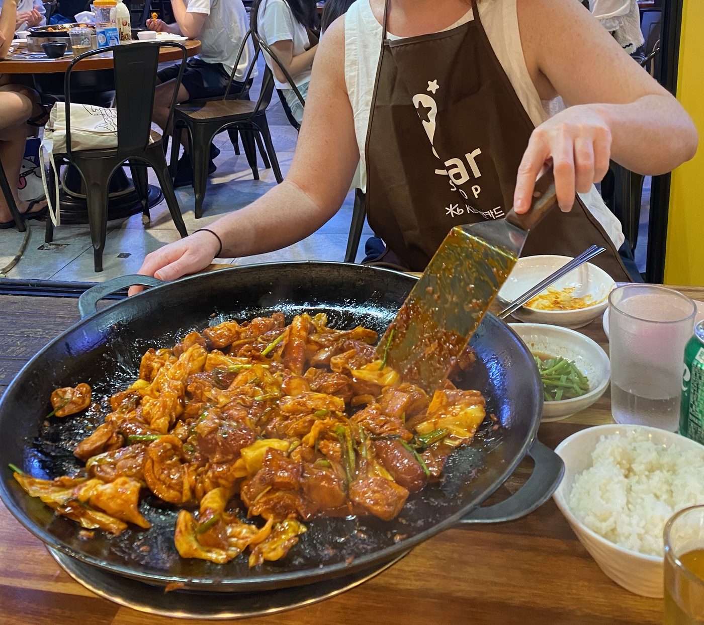 Dak-galbi (spicy stir-fried chicken) cooking on a hot iron griddle