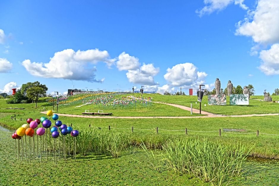 Imjingak Peace Park with colorful balloon sculptures, pinwheel field, and stone statues on a green hillside