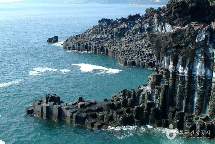 Daepo Jusangjeolli columnar basalt cliffs meeting the sea on Jeju's south coast